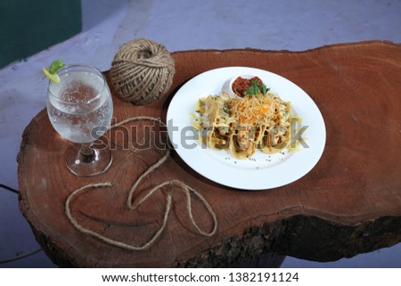 mexican chicken tacos served on a wooden table with sauces and drink 