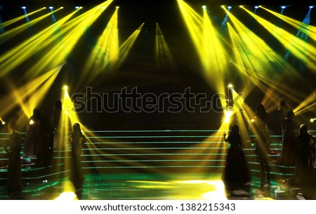 Make it Blur out focus Group silhouette of Miss Beauty Pageant Contest stand on left right side of world class stage with yellow lighting beam shine to contestances, low exposure, copyspace empty area Royalty-Free Stock Photo #1382215343