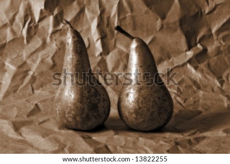 sepia-toned picture of two pears on a distressed background; variety 'conference'
