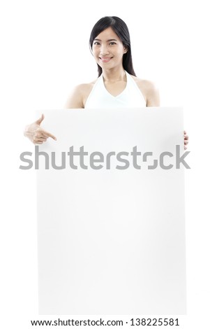 casual woman standing behind a blank board on white background (green concept)