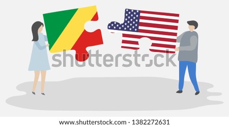 Couple holding two puzzles pieces with Congolese and American flags. Republic of the Congo and United States of America national symbols together.