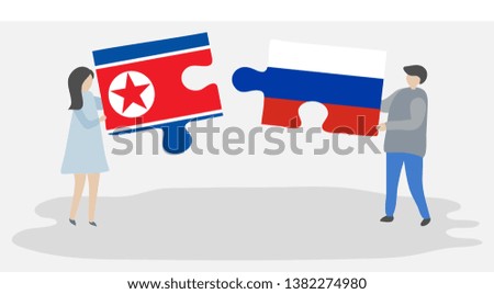 Couple holding two puzzles pieces with North Korean and Russian flags. North Korea and Russia national symbols together.
