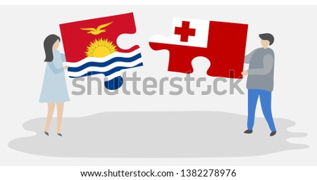 Couple holding two puzzles pieces with I-Kiribati and Tongan flags. Kiribati and Tonga national symbols together.