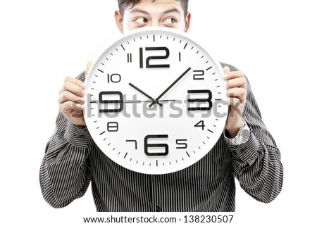 Time concept,Businessman holding big clock and give the expression on his face