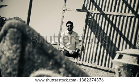 Man sitting in an abandoned metallic boat unique photo