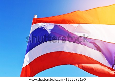 Low angle of the Thai flag with sunny sky. Thai national flag use for background and decorative.