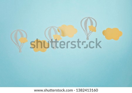 Mock up with paper clouds and flying balloons over the blue pastel background 