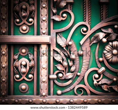 Decorative decoration of metal gates with forged flowers and leaves.
