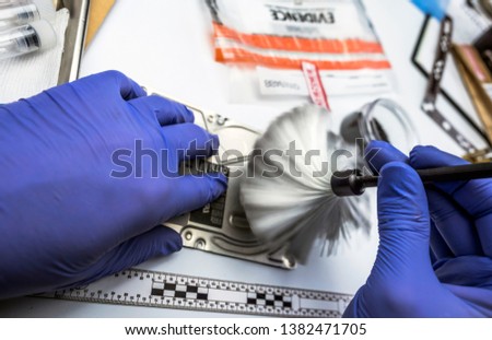 Police scientific analyzes cover of hard drive to find traces in the laboratory scientific, conceptual image
