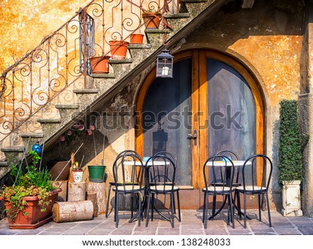 tables and chairs at a bistro in italy
