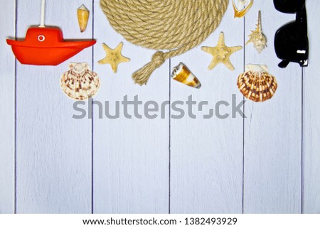 Different marine elements on a light wooden background. Marine objects on wooden boards. Place for text