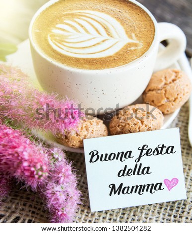 sunny morning breakfast - cup of coffee,  flowers and macaroon with Happy Mother day text in italian