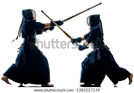 two Kendo martial arts fighters combat fighting in silhouette isolated on white bacground Royalty-Free Stock Photo #1382527139