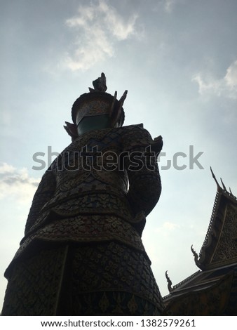The back of the giant guarding the door in the Temple of the Emerald Buddha, Thailand, the shadows