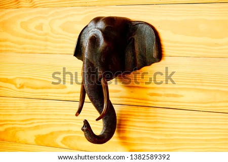 Wood elephant,selective focus close up wood elephant on wood background.
