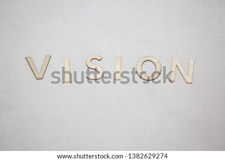 white wooden letters saying vision on white background