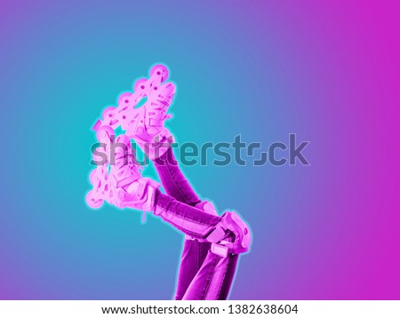 Feet in roller skates in purple and turquoise. Vaporwave style.