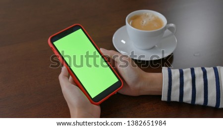 Woman use of mobile phone with green screen 