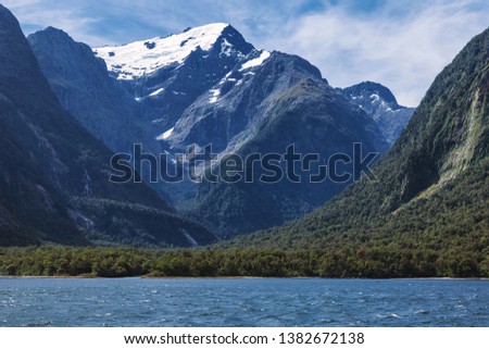 Huge snowy mountains view from Milford Sound in New Zealand South Island