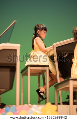 Girl playing at a piano presentation