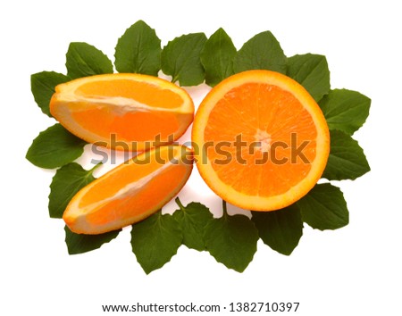 Slice and half orange fruit with green leaves of mint isolated on white background. Creative healthy food concept. Nature, juice. Flat lay, top view