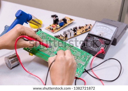 Close up of the hand men hold tool repairs electronics manufacturing Services,Repair of electronic devices, tin soldering parts.