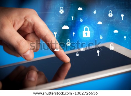 Hand holding tablet with online security system concept