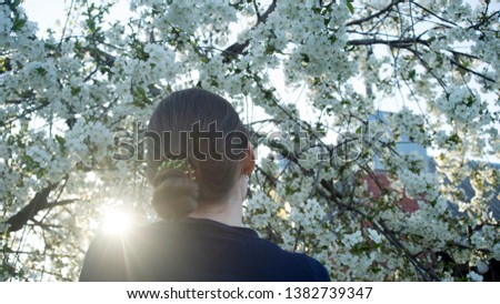 Beautiful spring girl in blooming tree