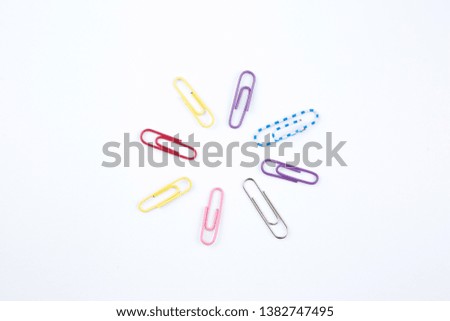 colorful paper clip lay on circle on a white background look like flower shape