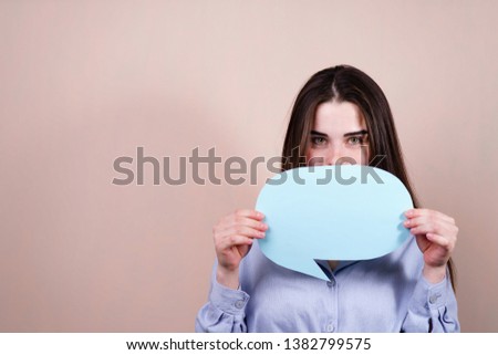 reply, thought, idea concept.  Template for advertisement. Young pensive woman holding empty speech bubble