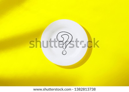 Empty white plate and question mark on yellow background. The concept of losing weight, diet, choice, breakfast and lunch, hotel, tropic. Flat lay, Top view.
