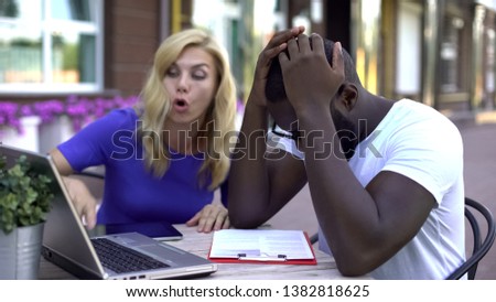 Nervous business people arguing, looking at laptop and paperboard, troubles Royalty-Free Stock Photo #1382818625