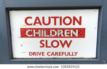 Warning sign to drive slowly as there are children about. 