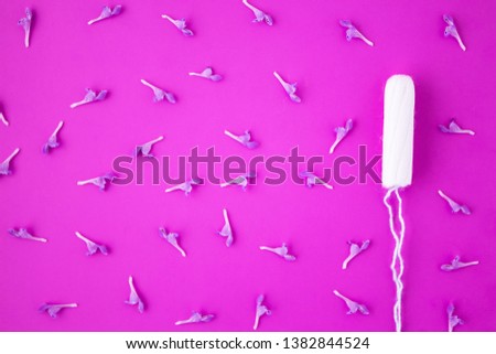 Menstruation, means of protection. Tampons on a pink background. Clean cotton tampon. Flat lay, top view.