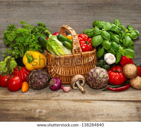 fresh vegetables and herbs on wooden background. raw food ingredients. country style picture
