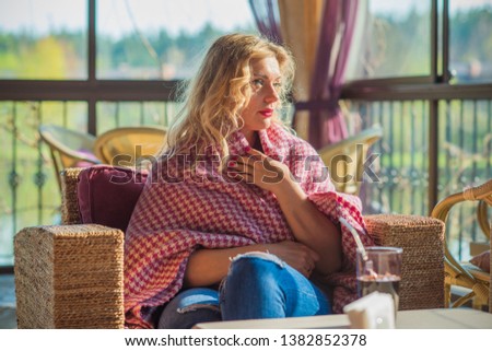 Woman at cozy cafe in plaid