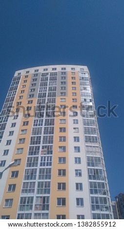 White and yellow skyscrapers apartment houses under blue sky