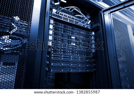 Blade server in rack cluster hard drives storage in internet data center room black and white tone