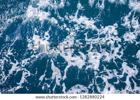 Blue frothy surface of sea water for the designs decoration and nature background concept