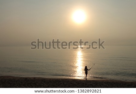 Girl taking fun selfie picture on beach vacation. Summer holiday woman happy at smartphone camera taking self-portrait 