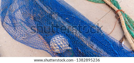 Industrial Fishing Equipment Fishnets and Fishing Lines lying on concrete in the port, fishing industry