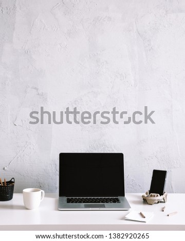 Business work table with laptop and phone. Office desk on grey wall, with copy space