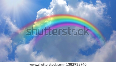 
The rainbow background and the sky with clouds floating in the sky and the light shining from the sun is a beautiful natural background.