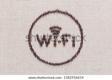 WiFi sign made from roasted coffee beans enclosed in circle isolated on creamy linea background shot top view, close up in the center.