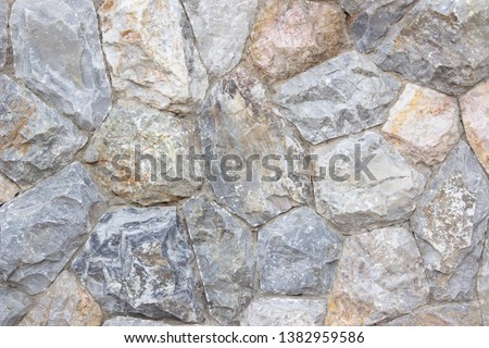 Background texture of Medieval natural stone wall textured background or boundary the Rock seamless abstract and fragment of a walls from a gray chipped stones ancient.
