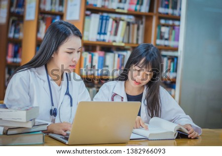 College age nursing or medical students talking in class searching forsubjectIn the library