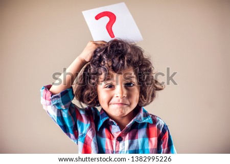 Kid boy with question mark. Children, education, emotions concept