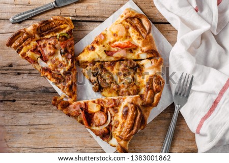 pizza in paper box on wooden background