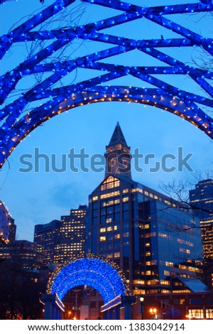 The Custom House in Boston is framed by a trellis adorned with Christmas lights