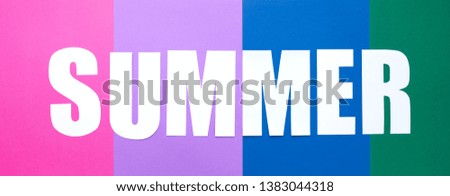 Lettering white summer on colorful paper background.